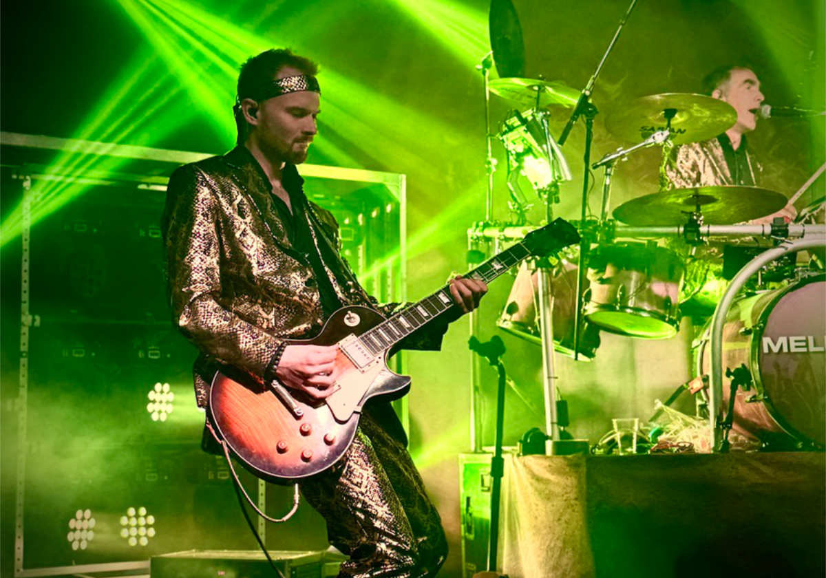 Person plays guitar and drum