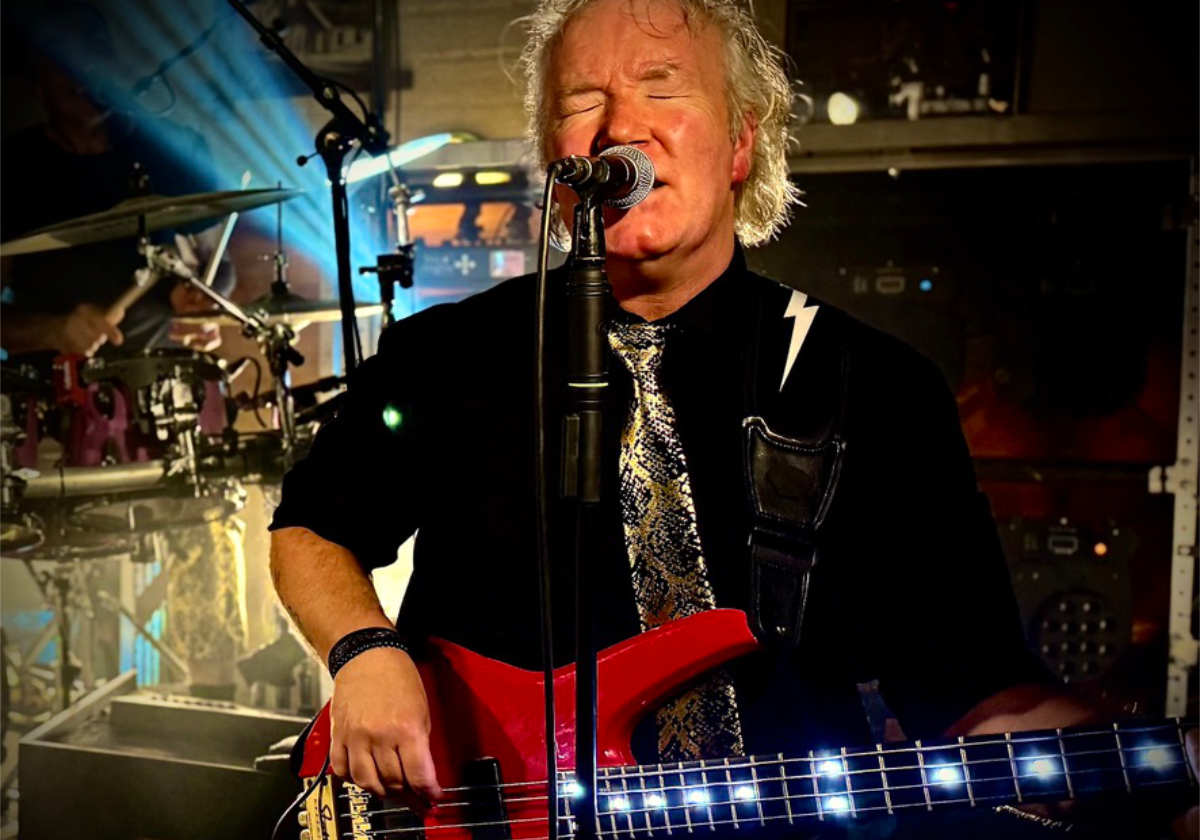 Musician plays guitar and sings